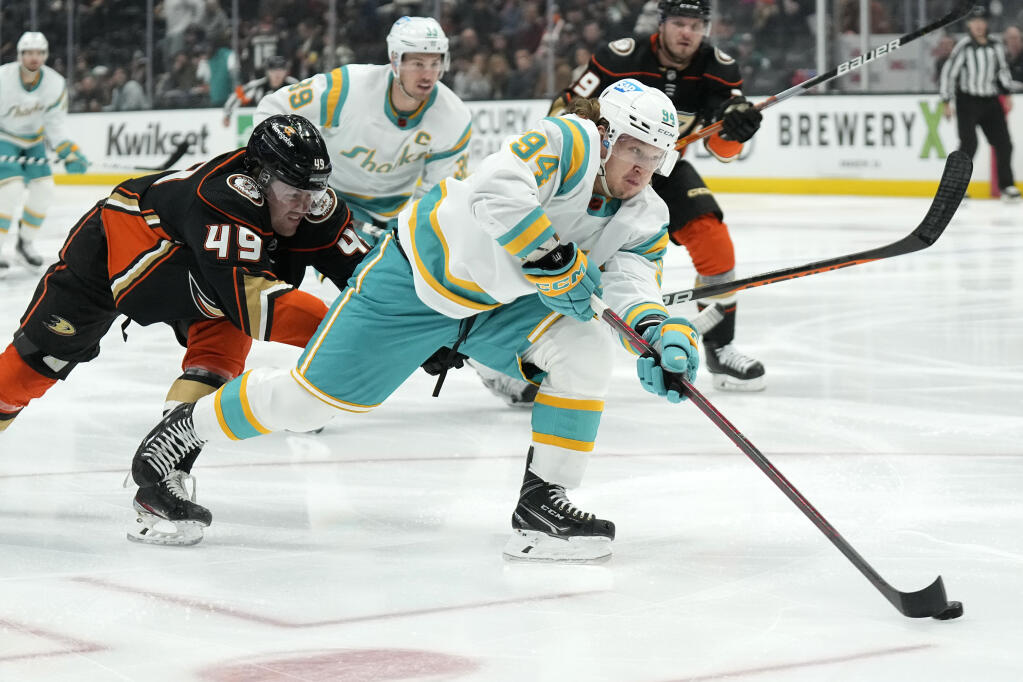 San Jose Sharks left wing Alexander Barabanov, right, moves the puck as Anaheim Ducks left wing Max Jones defends during the first period. (AP Photo/Mark J. Terrill)