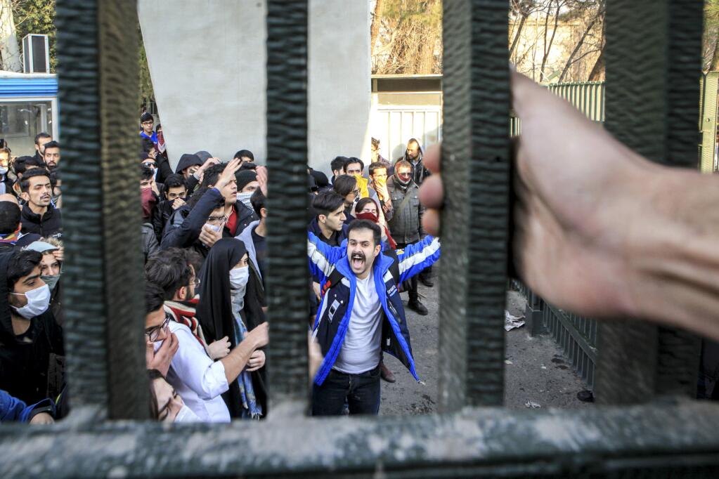 In this Saturday, Dec. 30, 2017 photo, by an individual not employed by the Associated Press and obtained by the AP outside Iran, university students attend an anti-government protest inside Tehran University, in Tehran, Iran. Demonstrations, the largest seen in Iran since its disputed 2009 presidential election, have brought six days of unrest across the country and resulted in over 20 deaths. (AP Photo)