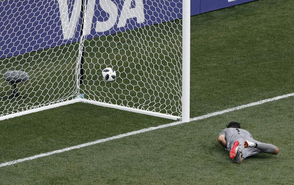 Panama goalkeeper Jaime Penedo lies on the ground after failing to stop a goal from England's Jesse Lingard during the group G match between England and Panama at the 2018 soccer World Cup at the Nizhny Novgorod Stadium in Nizhny Novgorod, Russia, Sunday, June 24, 2018. (AP Photo/Darko Bandic)
