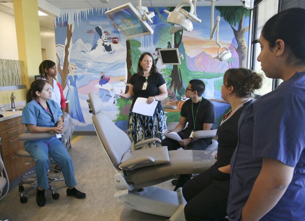 Dentist Ramona English talks to Dentists, Dental Assistants, and Sterilizing Specialists as they go through training in the new children's dental area of the Petaluma Health Center's new Rohnert Park Health Center at 5900 State Farm Drive in Rohnert Park on Monday, July 27, 2015. (SCOTT MANCHESTER/ARGUS-COURIER STAFF)