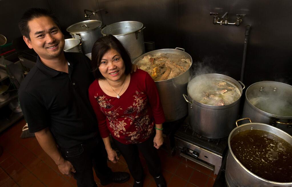 Simply Vietnam manager Jon Nguyen with his mother/chef Be Nguyen in the kitchen at Simply Vietnam. (photo by John Burgess/The Press Democrat)