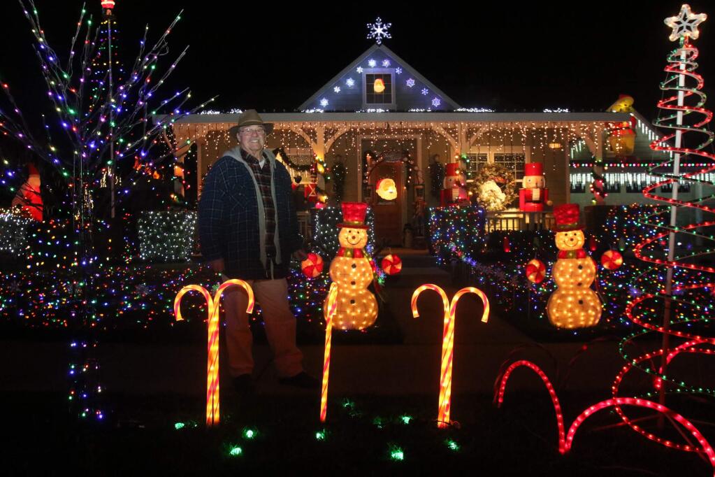 Michael Cruchon and his first place winning home at 1803 Hartman Lane in the 2015 Decorated Homes Contest on Monday, December 14, 2015. (SCOTT MANCHESTER/ARGUS-COURIER STAFF)