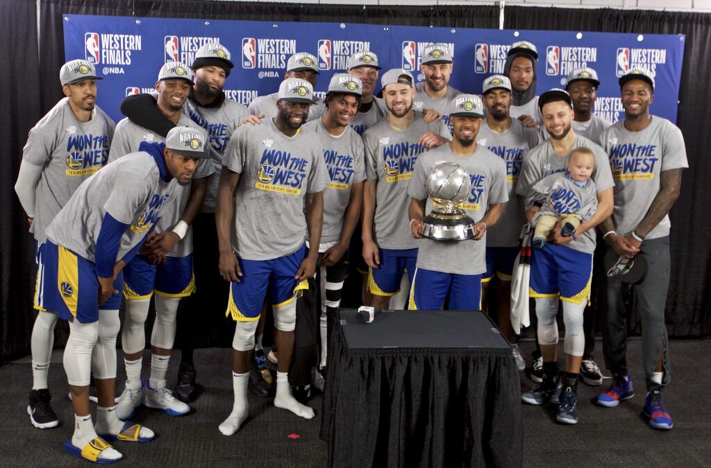 The Golden State Warriors players pose with the Western Conference Championship trophy after Game 4 of the NBA Western Conference finals against the Portland Trail Blazers Monday, May 20, 2019, in Portland, Ore. (AP Photo/Craig Mitchelldyer)