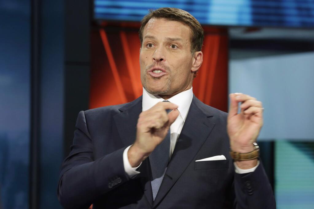 FILE - In this March 17, 2016, file photo, motivational speaker Tony Robbins is interviewed during a taping of 'Wall Street Week,' on the Fox Business Network in New York. Fire officials say more than 30 people attending a Tony Robbins event Thursday, June 23, 2016, in Dallas have been treated for burns after the motivational speaker encouraged them to walk on hot coals. (AP Photo/Richard Drew, File)