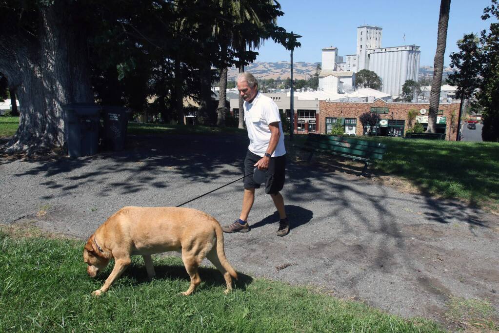 Retired Petaluma fireman Dennis Noreil wlaks his dog Leo in Penry Park in Petaluma on Monday afternoon July 3, 2017. Scott Manchester/For The Argus-Courier