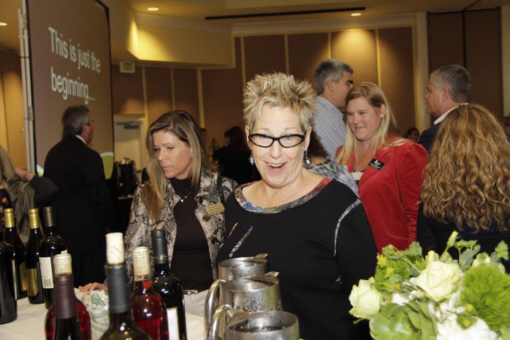 Executive Director of the Petaluma Arts Center, Val Richman enjoying the selections of wine during the Petaluma Community Foundation's Stronger Together Luncheon at the Sheraton Sonoma County Hotel in Petaluma on Friday, October 24, 2014. (JIM JOHNSON/FOR THE ARGUS-COURIER)