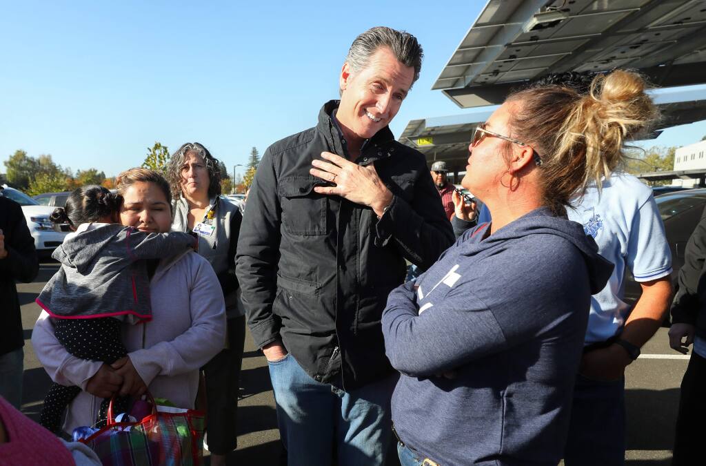 California Governor Gavin Newsom talks with Kincade fire evacuee Kellie Kingwell, while visiting the Redwood Empire Food Bank's crisis truck in Santa Rosa on Wednesday, October 30, 2019. (Christopher Chung/ The Press Democrat)