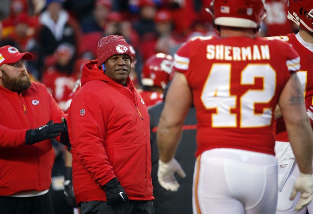 FILE - In this Jan. 20, 2019, file photo, Kansas City Chiefs offensive coordinator Eric Bieniemy watches players before the team's AFC championship NFL football game against the New England Patriots in Kansas City, Mo. The Chiefs have perhaps the most dynamic offense in the NFL and the San Francisco 49ers feature one of the stingiest defenses in the league. The men in charge of the units got interviews for head coaching but were passed over. (AP Photo/Charlie Riedel, File)