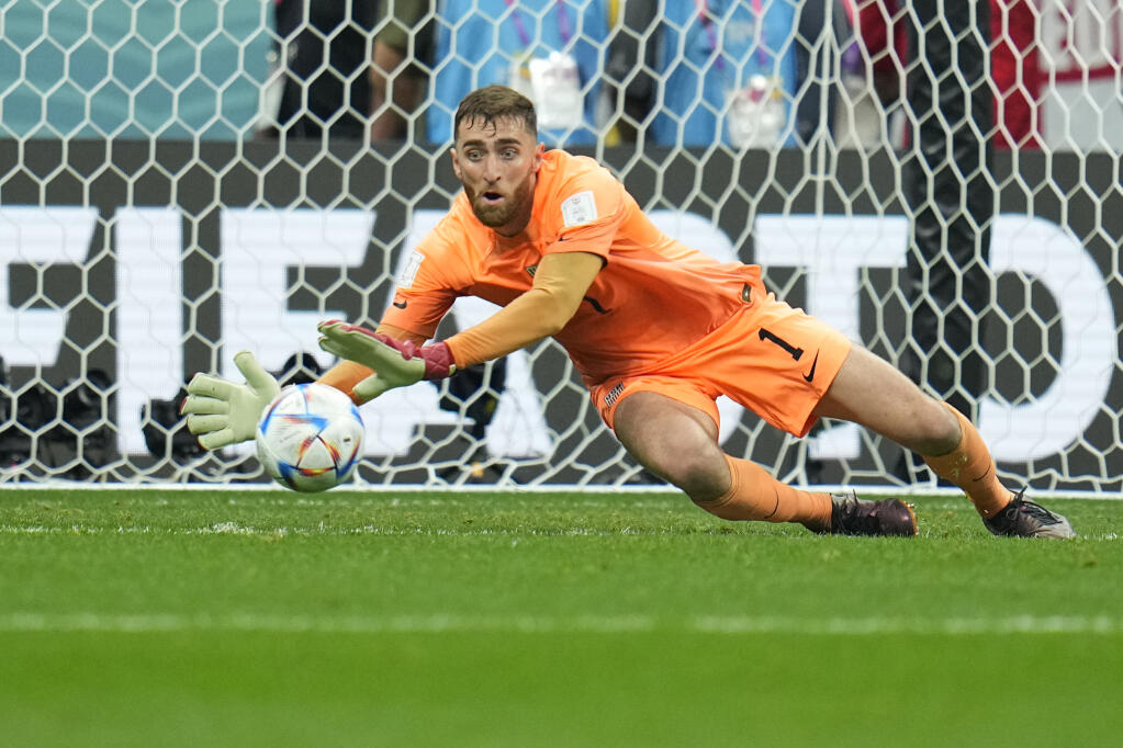 Goalkeeper Matt Turner of the United States makes a save shot by England's Mason Mount during the World Cup group B soccer match between England and The United States, at the Al Bayt Stadium in Al Khor , Qatar, Friday, Nov. 25, 2022. (AP Photo/Julio Cortez)
