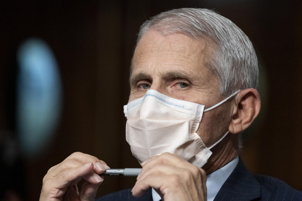 FILE - Dr. Anthony Fauci, director of the National Institute of Allergy and Infectious Diseases, listens during opening statements during a Senate Health, Education, Labor, and Pensions Committee hearing on Capitol Hill, Nov. 4, 2021, in Washington. Fauci, the nation's top infectious disease expert who became a household name, and the subject of partisan attacks, during the COVID-19 pandemic, announced Monday he will depart the federal government in December after more than 5 decades of service.  (AP Photo/Alex Brandon, File)