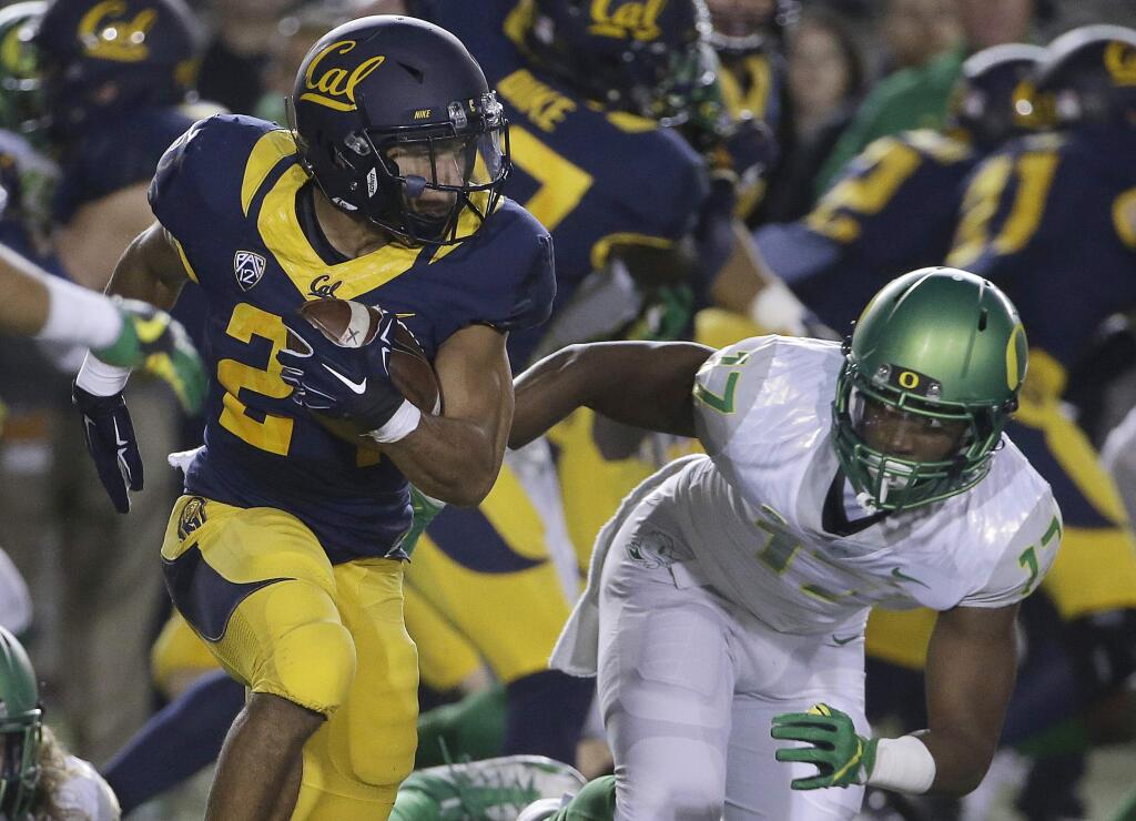 California's Khalfani Muhammad carries against Oregon during the first half of an NCAA college football game in Berkeley, Calif., Friday, Oct. 21, 2016. (AP Photo/Jeff Chiu)