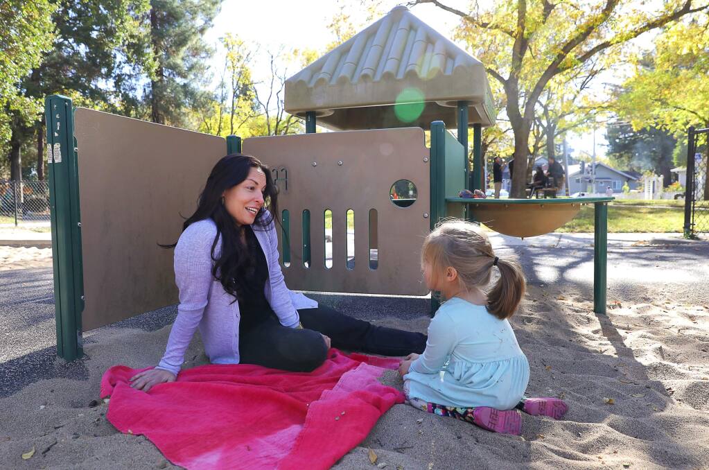Santa Rosa City Council member Victoria Fleming plays with her daughter, Evie, at Humboldt Park in Santa Rosa on Wednesday, Nov. 7, 2018. (Christopher Chung / The Press Democrat, 2018)