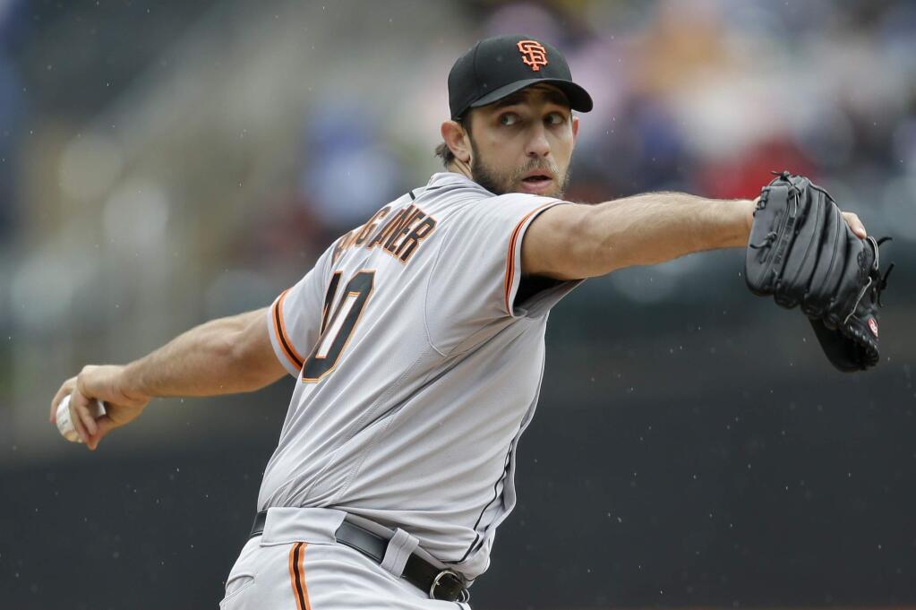 San Francisco Giants starting pitcher Madison Bumgarner throws during the second inning of the baseball game against the New York Mets at Citi Field, Sunday, May 1, 2016 in New York. (AP Photo/Seth Wenig)