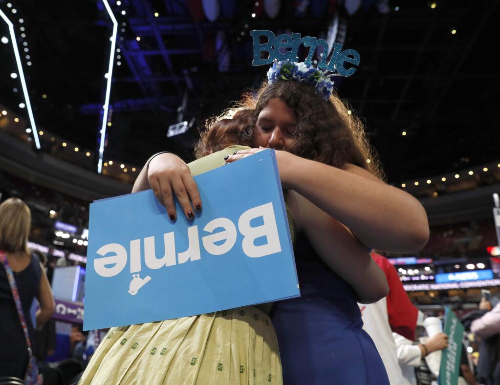 Pennsylvania delegates Amanda McIllmurray and Katherine Sayder cry after Former Democratic Presidential candidate, Sen. Bernie Sanders, I-Vt., spoke to delegations during the first day of the Democratic National Convention in Philadelphia , Monday, July 25, 2016. (AP Photo/Carolyn Kaster)