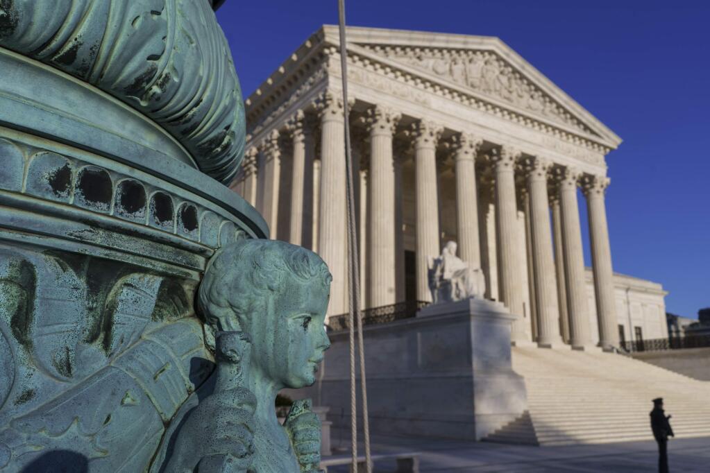 The Supreme Court is seen in Washington, April 20, 2018. The Supreme Court says employers can prohibit their workers from banding together to complain about pay and conditions in the workplace. (AP Photo/J. Scott Applewhite)