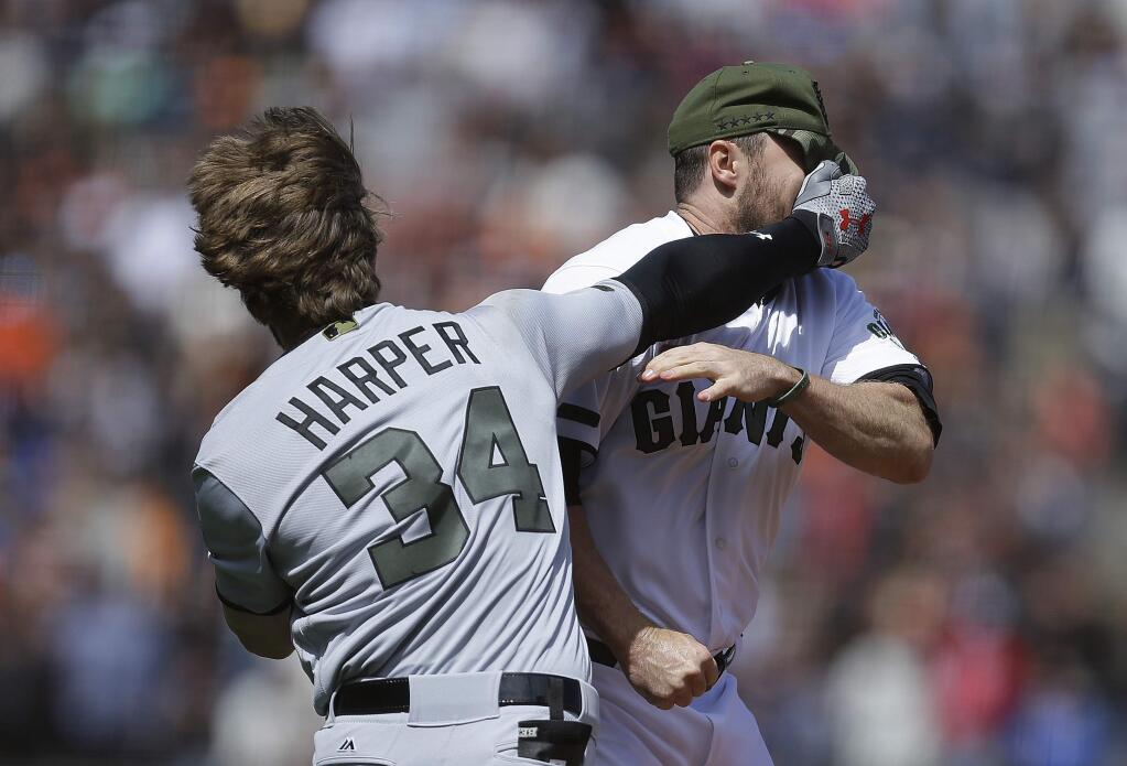 Washington Nationals' Bryce Harper (34) hits San Francisco Giants' Hunter Strickland in the face after being hit with a pitch in the eighth inning of a baseball game Monday, May 29, 2017, in San Francisco. (AP Photo/Ben Margot)
