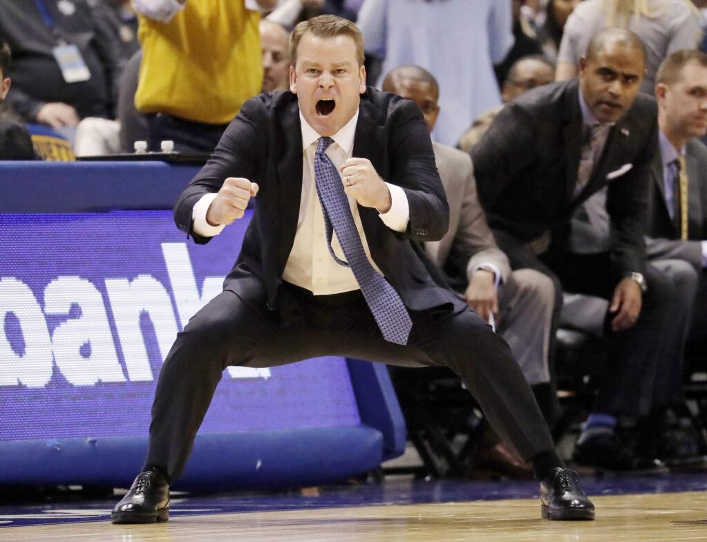 FILE - In this Dec. 28, 2016, file photo, Marquette head coach Steve Wojciechowski reacts during the second half of an NCAA college basketball game against Georgetown in Milwaukee. In this, the 100th anniversary of Marquette basketball and 40th anniversary of the Al McGuire-coached team winning the national title, current coach Steve Wojciechowski is marking his own important milestone. The Golden Eagles are back in the NCAA tournament after a four-year absence. (AP Photo/Morry Gash, File)