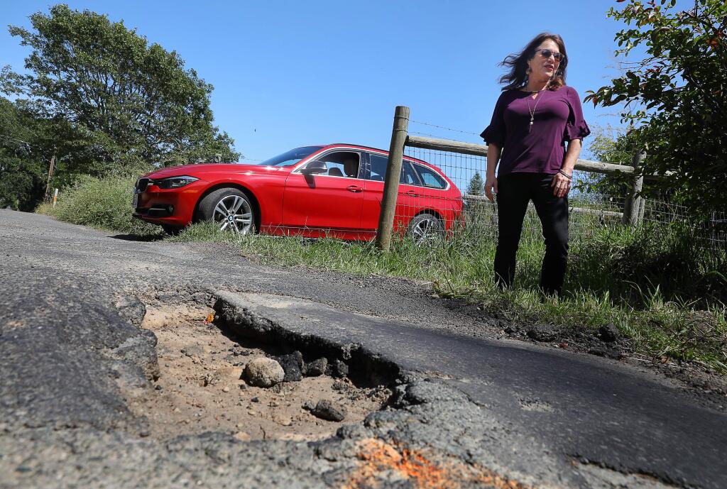 Edie Otis damaged two tires on a pothole, like this one on East Hurlbut Avenue in Sebastopol. According to state law, people who damage their vehicles have the ability to sue the county if they can prove the road division was aware of the road hazard and didn't act with expediency.(Christopher Chung/ The Press Democrat)