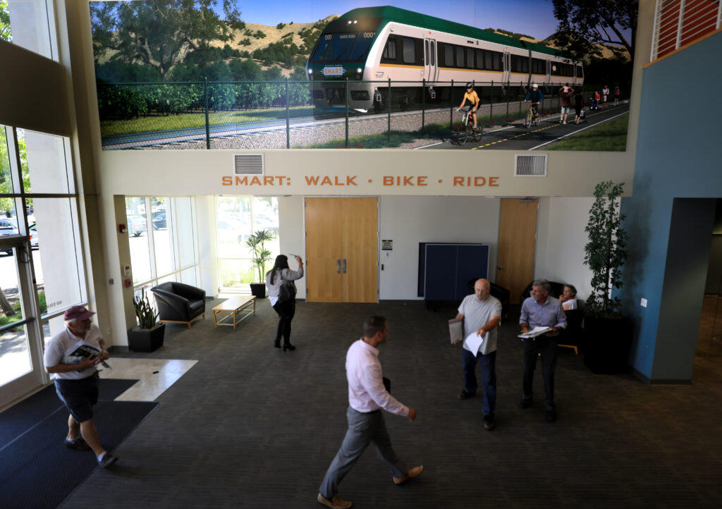 At SMART headquarters in Petaluma, Wednesday, July 17, 2019 people walk through the lobby as they prepare to attend a SMART board meeting about the recent deaths on the commuter rail’s corridor in Sonoma County.   (Kent Porter / The Press Democrat) 2019