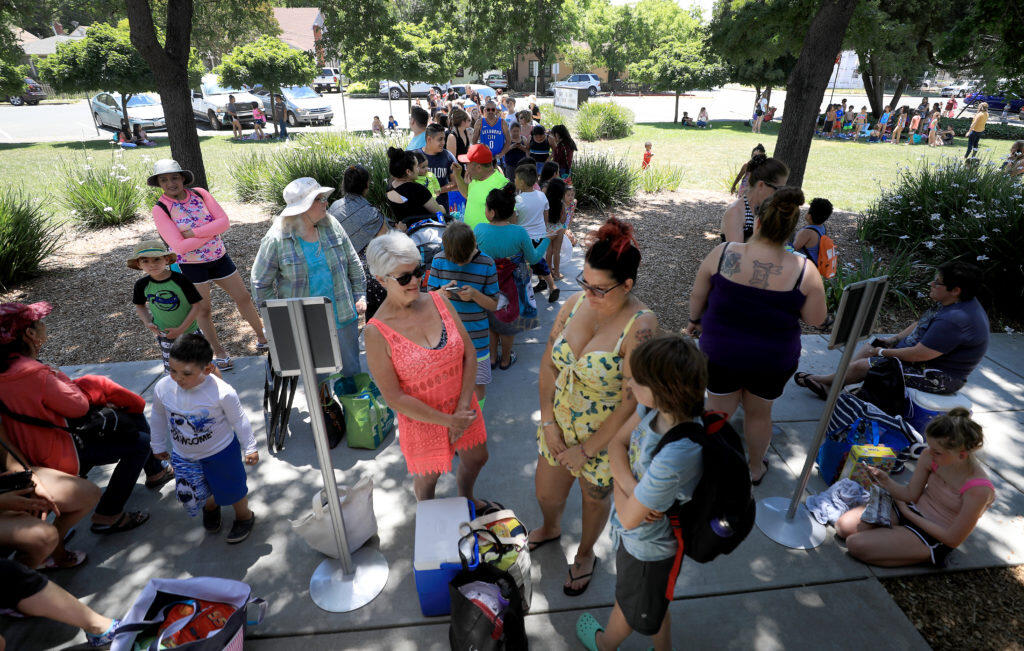 As temperatures climbed close to the century mark, a line formed at the  Ridgeway Swim Center for the public swim, Monday, June 10, 2019 in Santa Rosa.  (Kent Porter / The Press Democrat) 2019