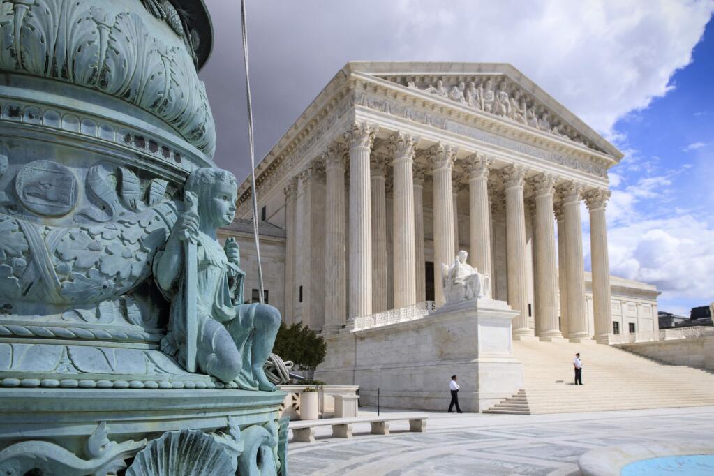 In this photo taken March 28, 2017, the Supreme Court Building is seen in Washington. The Supreme Court is granting the Trump administration's request to more strictly enforce its ban on refugees, at least until a federal appeals court weighs in. But the justices are leaving in place a lower court order that makes it easier for travelers from six mostly Muslim countries to enter the U.S. (AP Photo/J. Scott Applewhite)