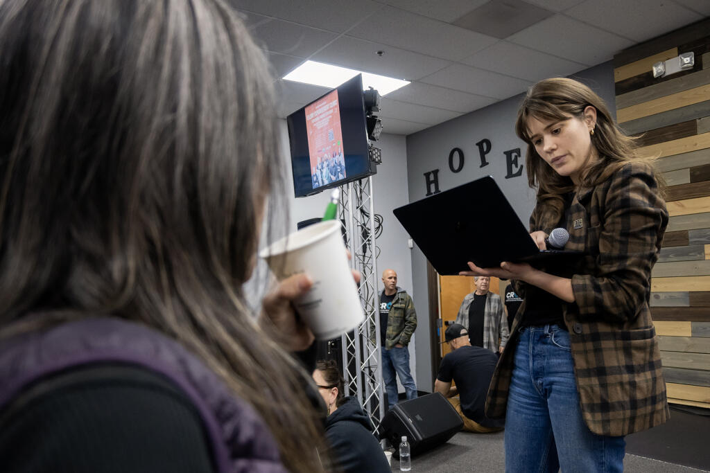 Celina Chapin, associate director of policy and activism at the Anti-Recidivism Coalition, answers questions from people attending a clinic on how to clear their criminal records at the New Beginnings Fellowship in South Sacramento on March 9, 2024. Photo by José Luis Villegas for CalMatters