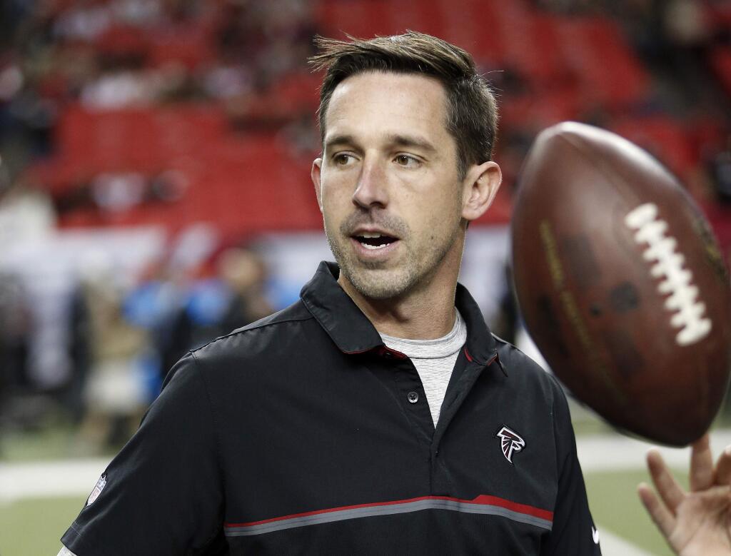 FILE - In this Dec. 18, 2016, file photo, Atlanta Falcons offensive coordinator Kyle Shanahan walks on the turf before an NFL football game against the San Francisco 49ers in Atlanta. Shanahan, expected to be one of the top targets for teams looking to replace head coaches, could be available for interviews this week. Falcons coach Dan Quinn said Monday, Jan. 2, 2017, “I'm sure he will be contacted by some teams.” (AP Photo/John Bazemore, File)