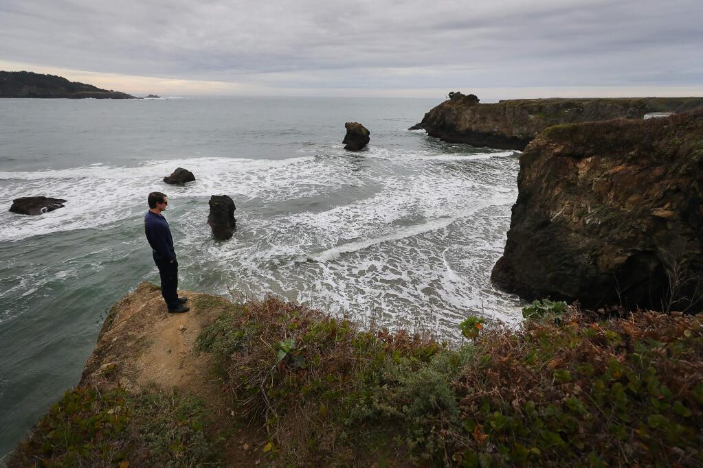 California State Parks lifeguard Ean Miller looks down at the cove where he rescued a surfer in distress and pulled another one in, on the south side of the Mendocino Headlands, near the mouth of the Big River, in November of 2018. Miller was awarded the Medal of Valor by the U.S. Lifeguard Association.(Christopher Chung/ The Press Democrat)