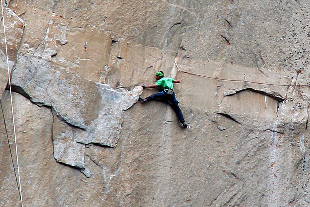 In this Jan. 9, 2015 photo provided by Tom Evans, Kevin Jorgeson climbs on what is known as pitch 15 during what has been called the hardest rock climb in the world: a free climb of El Capitan, the largest monolith of granite in the world, a half-mile section of exposed granite in California's Yosemite National Park. The first climber reached its summit in 1958, and there are roughly 100 routes up to the top. (AP Photo/Tom Evans, elcapreport)