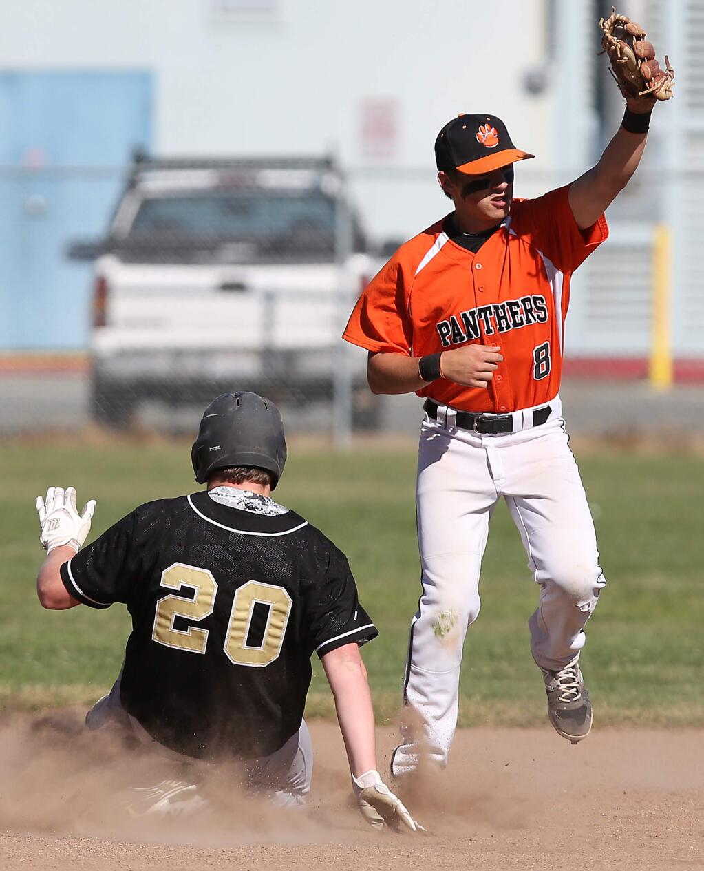 Windsor's John Plinski slides safely into second as the ball comes late to Santa Rosa's Nate Turnipseed during the game held at Santa Rosa High School, Wednesday, April 1, 2015. (Crista Jeremiason / The Press Democrat)