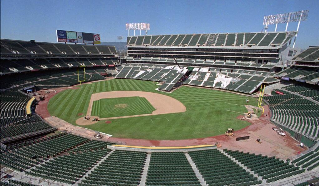 FILE -- This Aug. 7, 1996, file photo, shows the Oakland Coliseum in transition from baseball to football field configuration in Oakland, Calif. A federal appeals court upheld the dismissal of antitrust claims in a lawsuit by the city of San Jose against Major League Baseball, which accused the sport of illegally blocking a proposed move of the Oakland Athletics to the area, Thursday, Jan. 15, 2015. (AP Photo/Ben Margot, File)