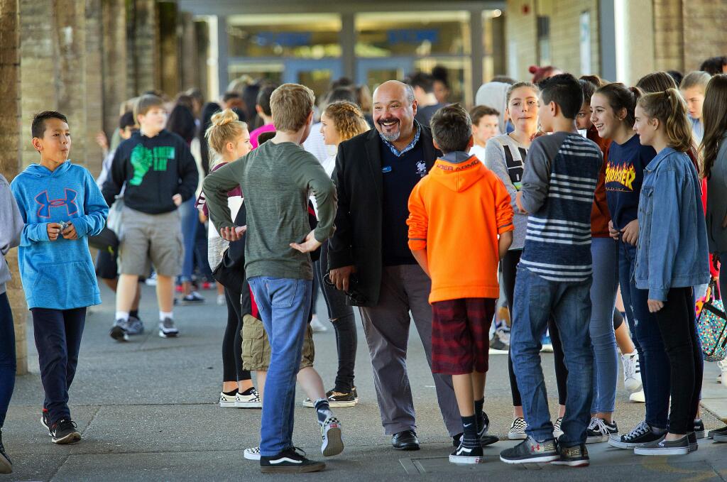 Rincon Valley Middle School and Santa Rosa Accelerated Charter principal Ed Navarro talks with students during lunch on Friday. Returning to routine and normalcy has been difficult for the 126 students who lost homes in the fire. (photo by John Burgess/The Press Democrat)