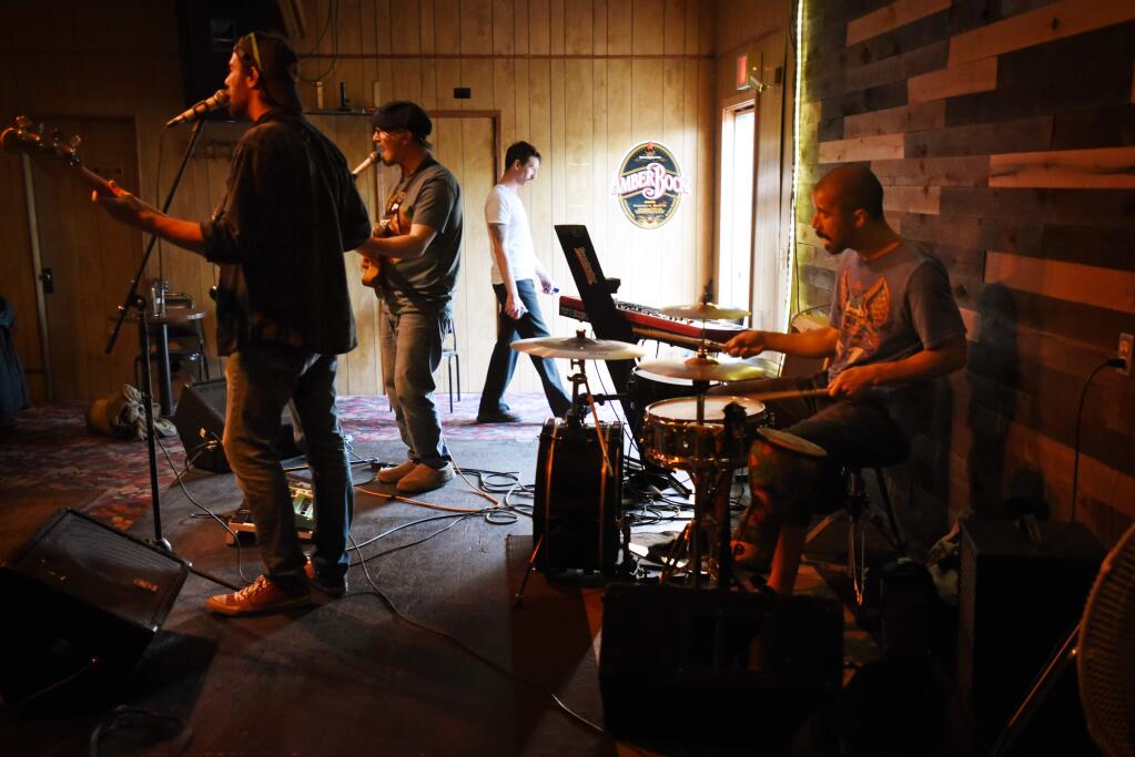 Member for the band the Front Room, from left, Nick Galotta on bass, Simon Croptom on guitar and Daniel Bowman on drums warming up before the start of during the Flood Relief Fundraiser for the Rio Nido Roadhouse held at the Forestville Club in Forestville, April 20, 2019.(Erik Castro/for The Press Democrat)