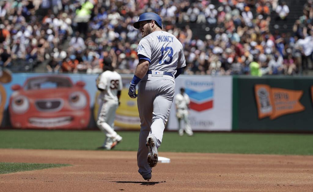 Los Angeles Dodgers' Max Muncy rounds the bases after hitting a solo home run off of San Francisco Giants pitcher Madison Bumgarner during the first inning of a baseball game in San Francisco, Sunday, June 9, 2019. (AP Photo/Jeff Chiu)