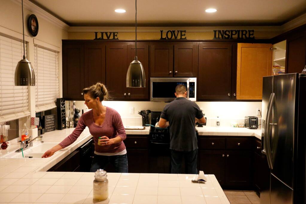 Jill and Manny Castrellon get started preparing dinner at their home, in Santa Rosa, California on Wednesday, January 6, 2016. (Alvin Jornada / The Press Democrat)