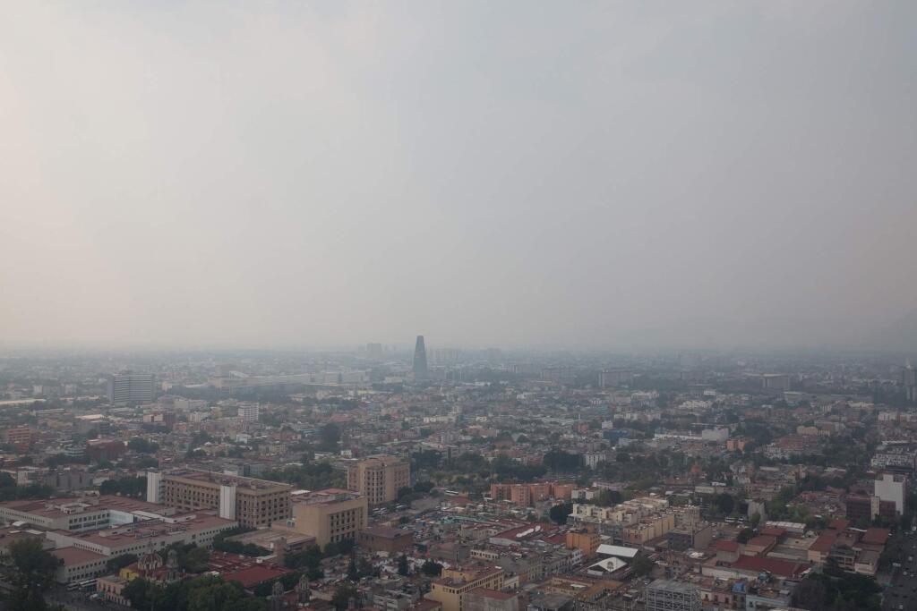 A haze of hazardous smoke covers Mexico City on May 15, 2019. A series of wildfires on the city and its outskirts have combined with stagnant weather conditions to cloak the metropolitan area of more than 22 million people in a gray cloud of air pollution. (Benedicte Desrus/Sipa USA/TNS)