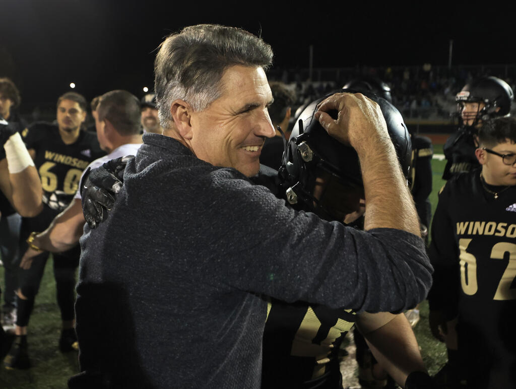 Windsor head coach Paul Cronin and player Joey Skinner congratulate one another after their victory against Benicia on Friday, Nov. 26, 2021. (Kent Porter / The Press Democrat)