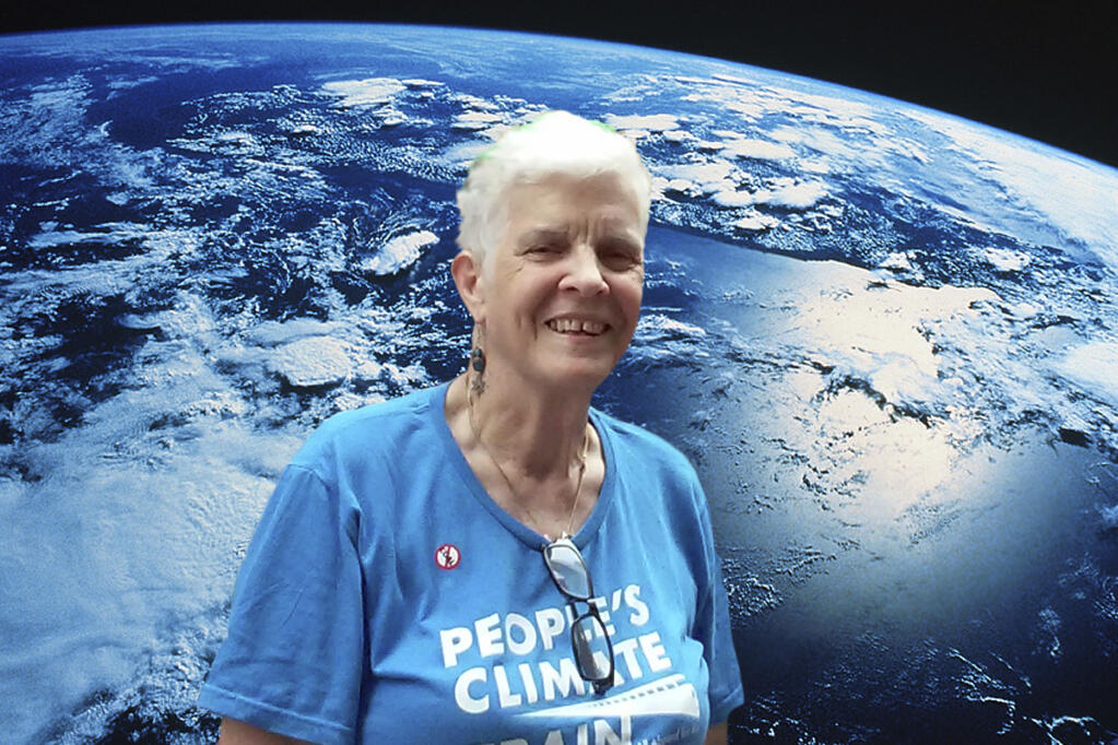 TISH LEVEE Flanked by the love of her life, Mother Earth. (Photo from Jewish groups 2014 climate march. - Courtesy Tish Levee)
