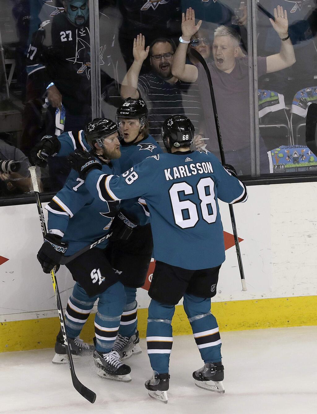 San Jose Sharks left wing Marcus Sorensen, center, is congratulated by defenseman Paul Martin (7) and right wing Melker Karlsson (68), from Sweden, after scoring a goal against the Anaheim Ducks during the first period of Game 4 of an NHL hockey first-round playoff series in San Jose, Calif., Wednesday, April 18, 2018. (AP Photo/Jeff Chiu)