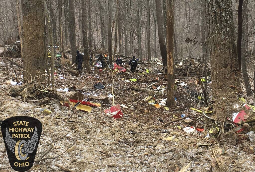 In this photo provided by the Ohio State Highway Patrol, authorities survey the scene of wreckage where a medical helicopter crashed in a remote wooded area in Brown Township, Ohio, on its way to pick up a patient, Tuesday, Jan. 29, 2019. (Ohio State Highway Patrol via AP)