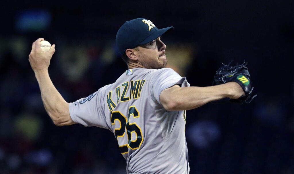 Oakland A's starting pitcher Scott Kazmir throws during a game against the Texas Rangers in 2014. (AP Photo/LM Otero)