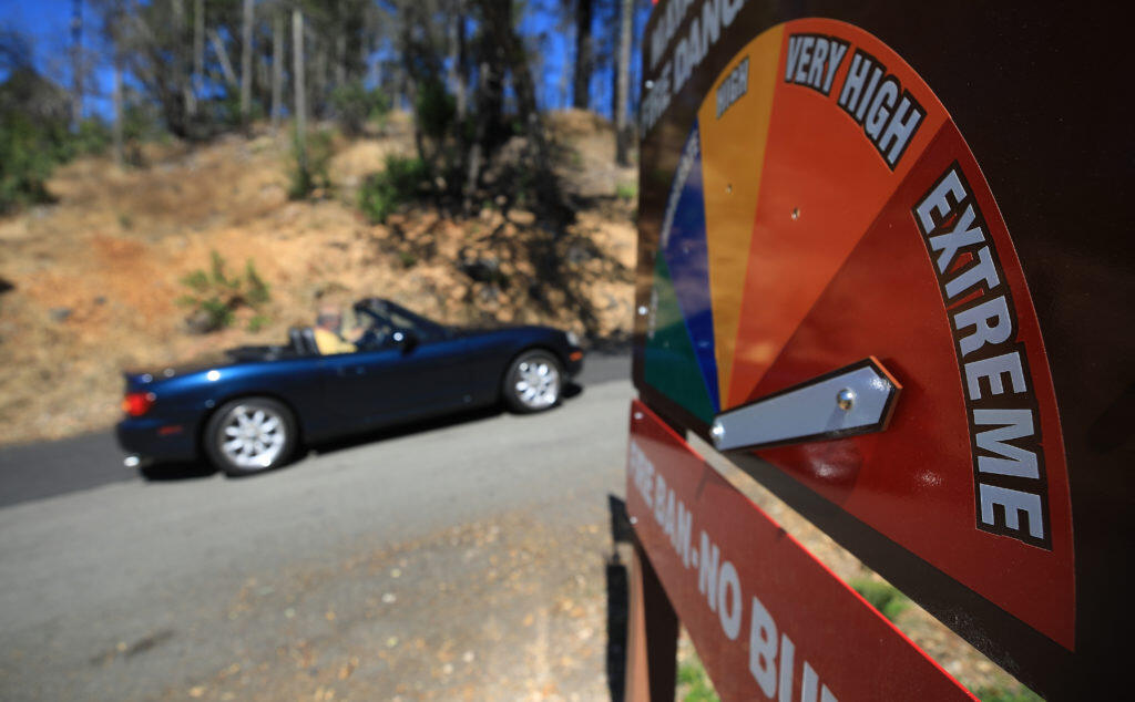 The Mayacamas Volunteer Fire Department tracks fire risk with a colorful sign. (Kent Porter / The Press Democrat