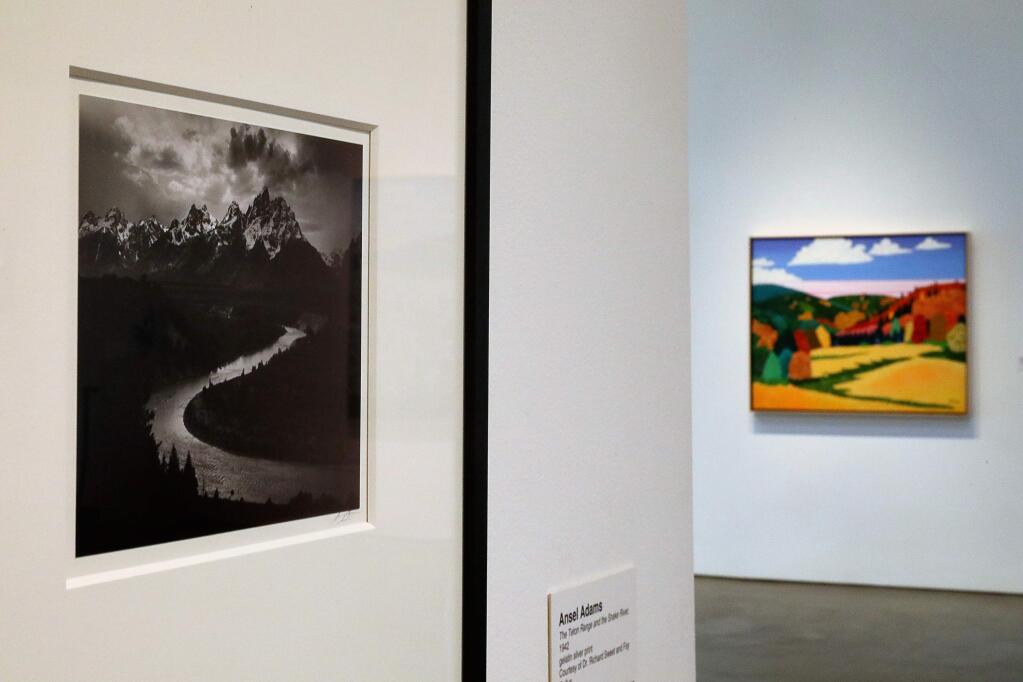 Ansel Adams' 'The Teton Range and the Snake River,' left, and Jack Stuppin's 'Catskill TaTaShu Farm II' are part of the Museum of Sonoma County's 'Landscape: Art to Activism' exhibit. (Christopher Chung/The Press Democrat)