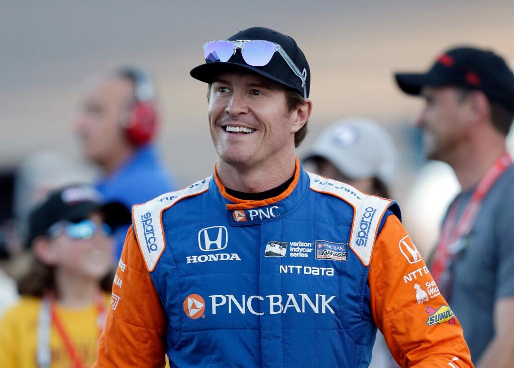FILE - In this Saturday, April 7, 2018, file photo, driver Scott Dixon smiles before the IndyCar auto race at Phoenix International Raceway in Avondale, Ariz. Dixon will be the latest IndyCar driver to enter the realm of reality TV when he auditions in Indianapolis next week for 'American Ninja Warrior. (AP Photo/Rick Scuteri, File)