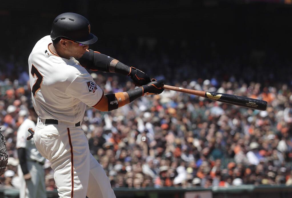 San Francisco Giants' Gorkys Hernandez hits a two-run single against the Miami Marlins during the sixth inning of a baseball game in San Francisco, Wednesday, June 20, 2018. (AP Photo/Jeff Chiu)