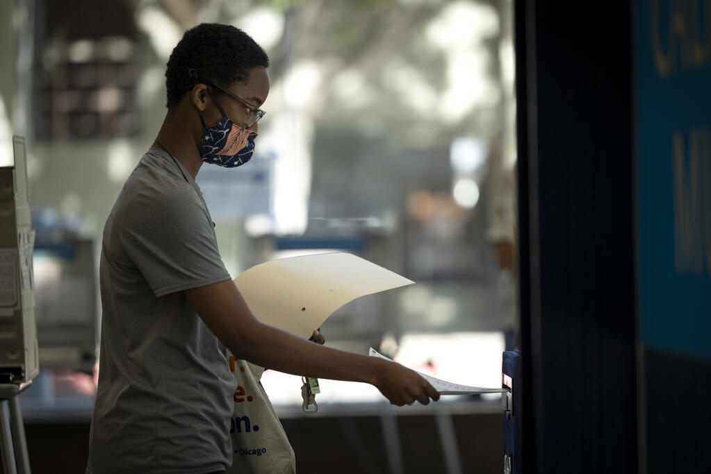 A voter casts their ballot at a voting site at the California Museum in downtown Sacramento on June 7, 2022. Photo by Miguel Gutierrez Jr., CalMatters