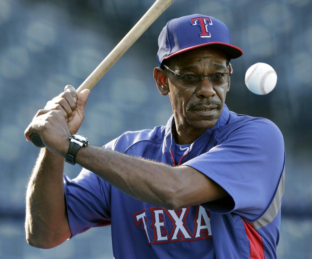 FILE - In this Sept. 3, 2014, file photo, then-Texas Rangers manager Ron Washington hits during fielding drills before the Rangers' baseball game against the Kansas City Royals in Kansas City, Mo. Washington is getting back into the big leagues, re-joining the Oakland Athletics as an instructor after nearly eight years as Rangers manager. Washington, who was a coach with the A's for 11 years before joining the Rangers, told The Associated Press in a text message Wednesday night, May 20, 2015, that he heard from general manager Billy Beane earlier in the day and would meet the A's in Tampa, Fla., on Friday. The 63-year-old Washington has been working with youth and college players in his native New Orleans. He led the Rangers to AL pennants in 2010 and '11. (AP Photo/Charlie Riedel, File)