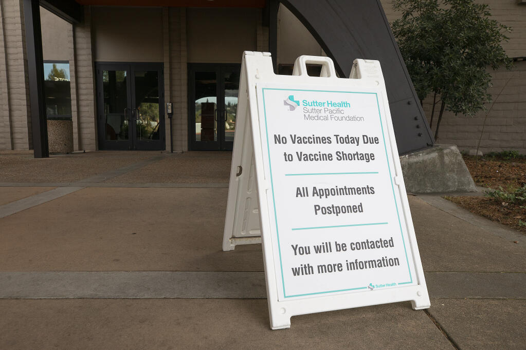 A sign announcing canceled vaccinations stands in front of the Luther Burbank Center COVID-19 vaccination site on Tuesday, March 2, 2021. (John Burgess/The Press Democrat)