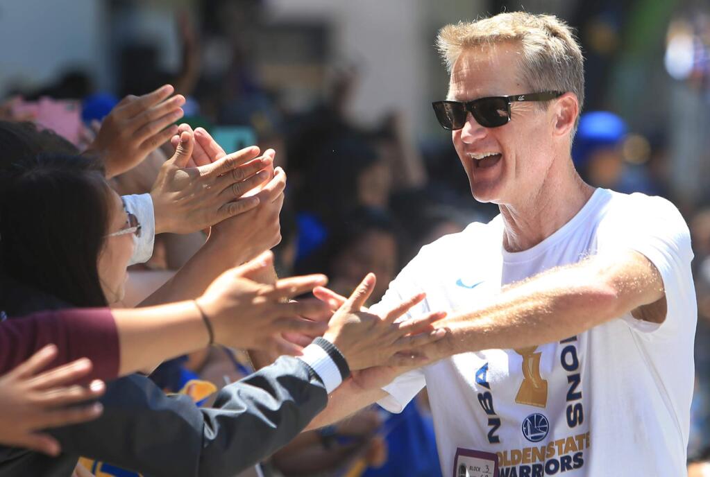Golden State Warrior coach Steve Kerr celebrates with Bay Area fans in Oakland, Tuesday, June 12, 2018 during the Warriors victory parade. (Kent Porter / The Press Democrat) 2018