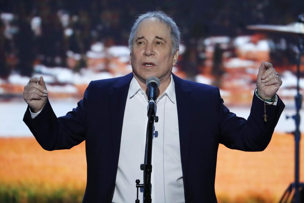 Singer-songwriter Paul Simon performs during the first day of the Democratic National Convention in Philadelphia , Monday, July 25, 2016. (AP Photo/J. Scott Applewhite)